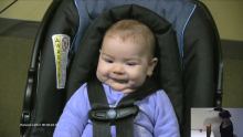 infant in seat watching video of woman picking up ball