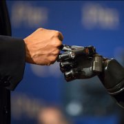 a robot and human fist bump